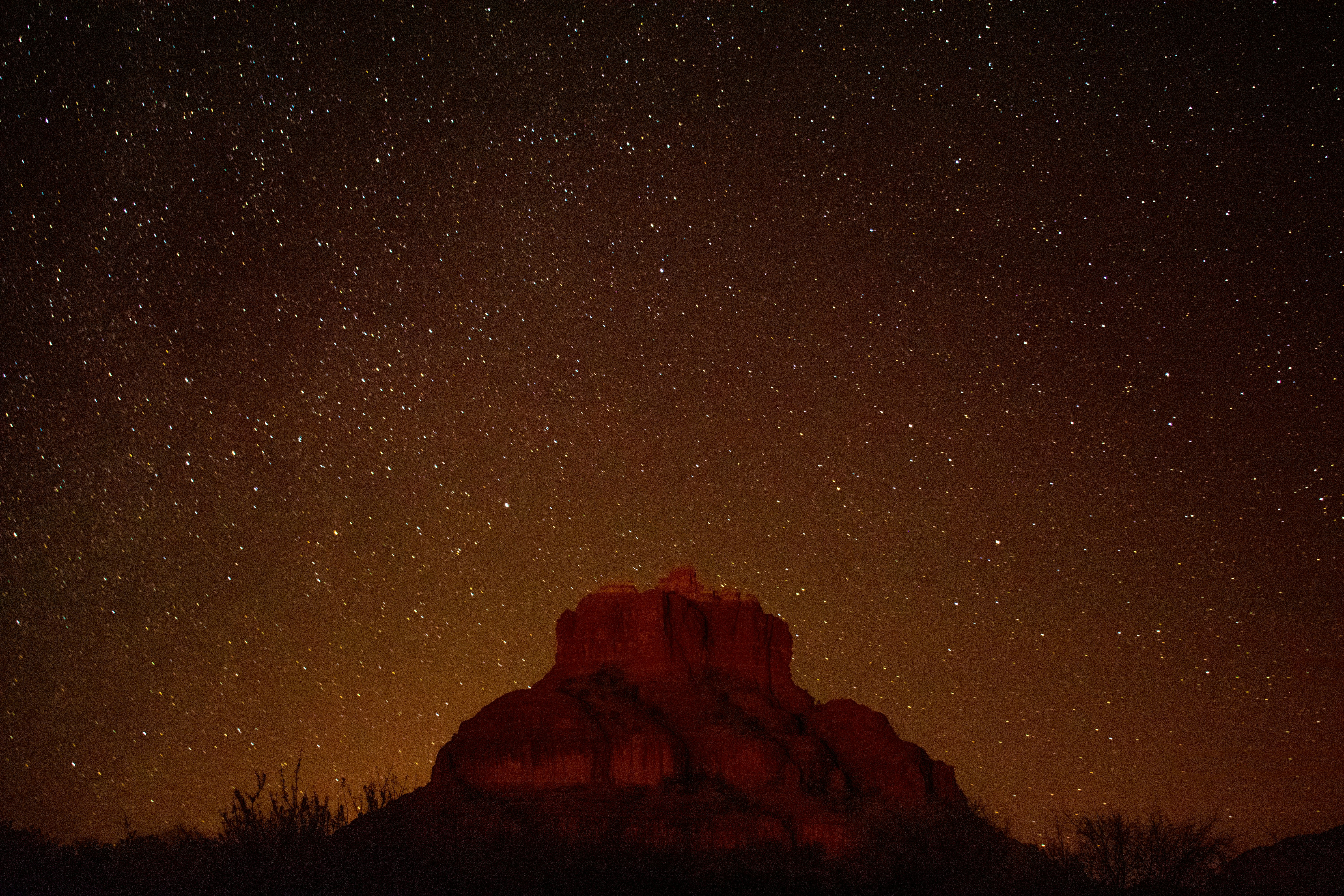 brown mountain under starry sky during nighttime in timelapse photography